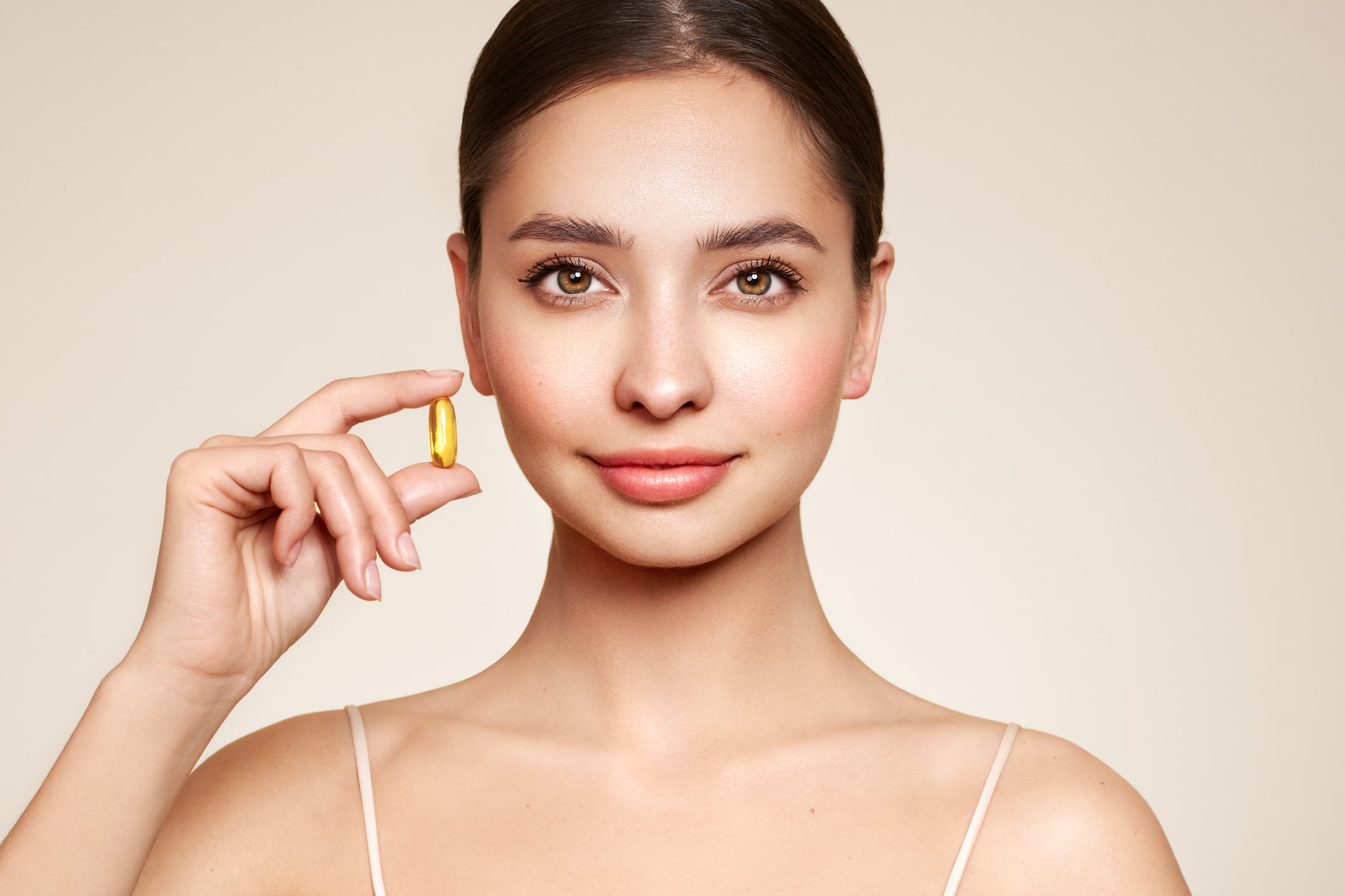 Vitamins. Close Up Of Happy Beautiful Girl With Pill With Cod Liver Oil Omega-3. Nutrition. Vitamin D, E, A Fish Oil Capsules. Healthy Lifestyle. Sport, Diet Concept