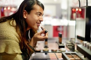 Non-binary person shopping for makeup.